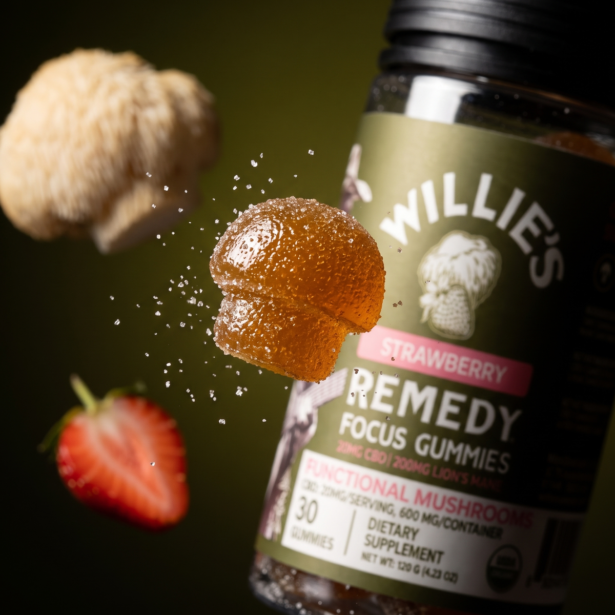 Close-up of a Focus CBD mushroom gummy in front of the Willie's Remedy jar