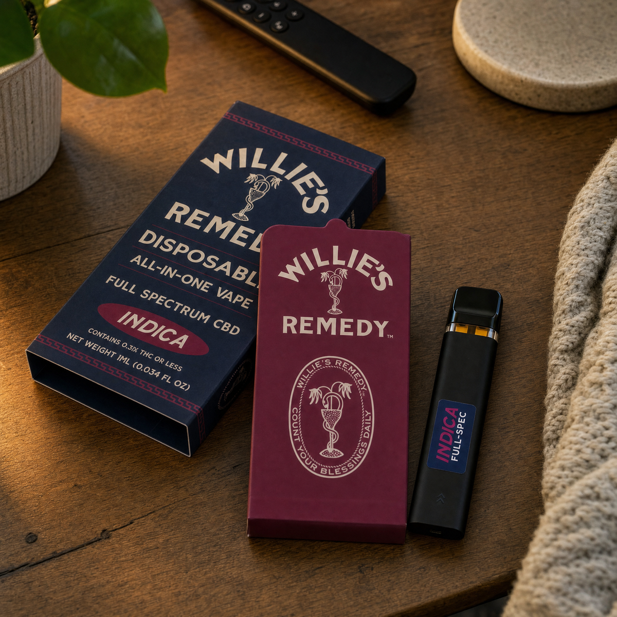 Willie's Remedy Full Spectrum Indica vape and boxes on a wooden table