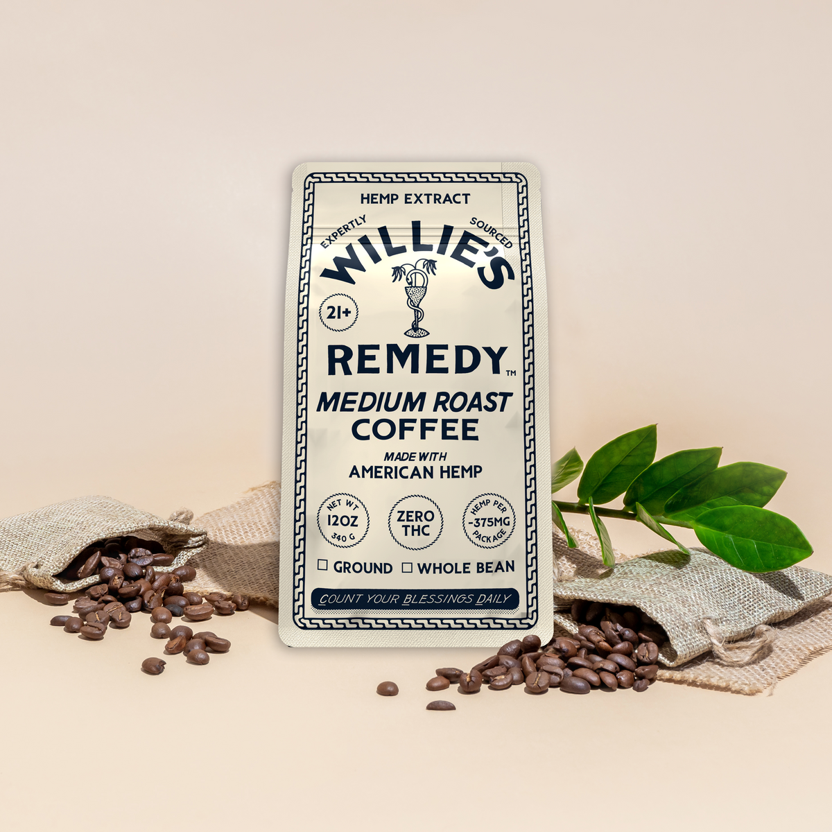 Willie's Remedy CBD Medium Roast Whole Bean Coffee bag with scattered coffee beans and a plant