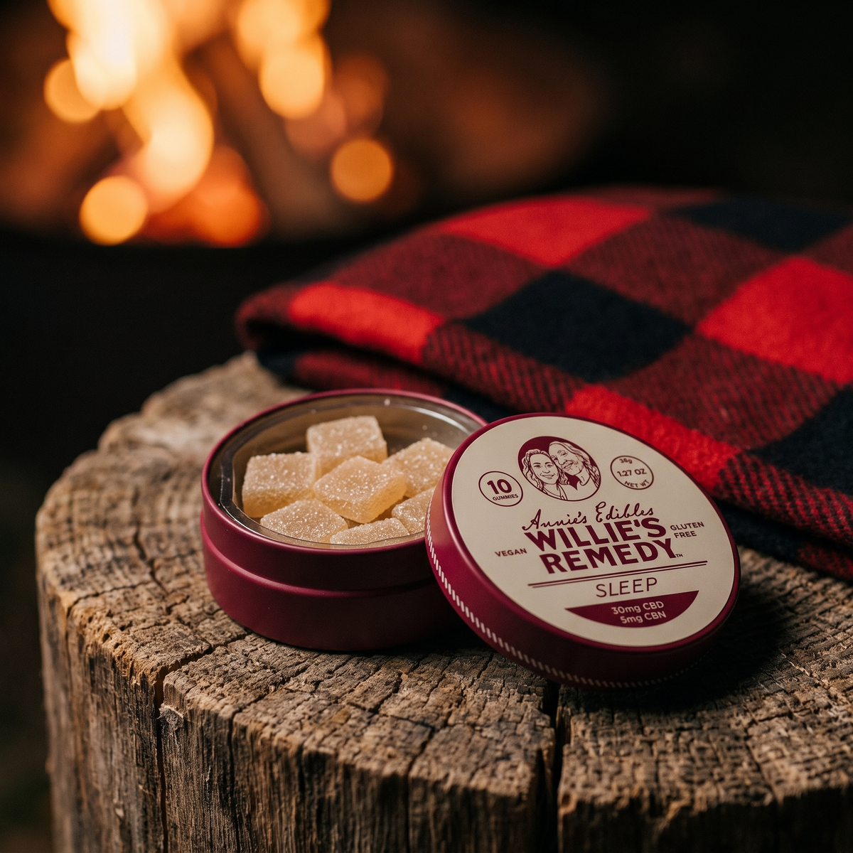 Open tin of Sleep CBD gummies on a wooden stump by a fireplace