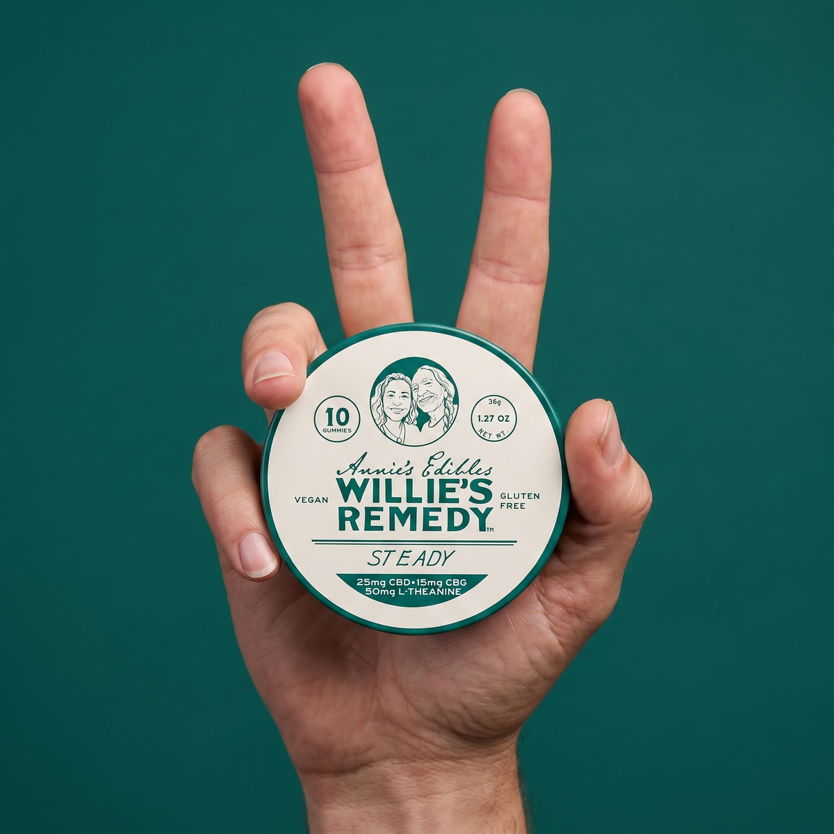 Hand holding a tin of Steady CBD gummies while making a peace sign